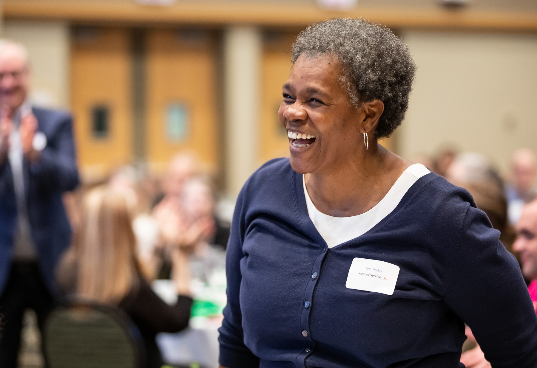 Tina Tindall stands to be recognized for her 35 years at DePaul.